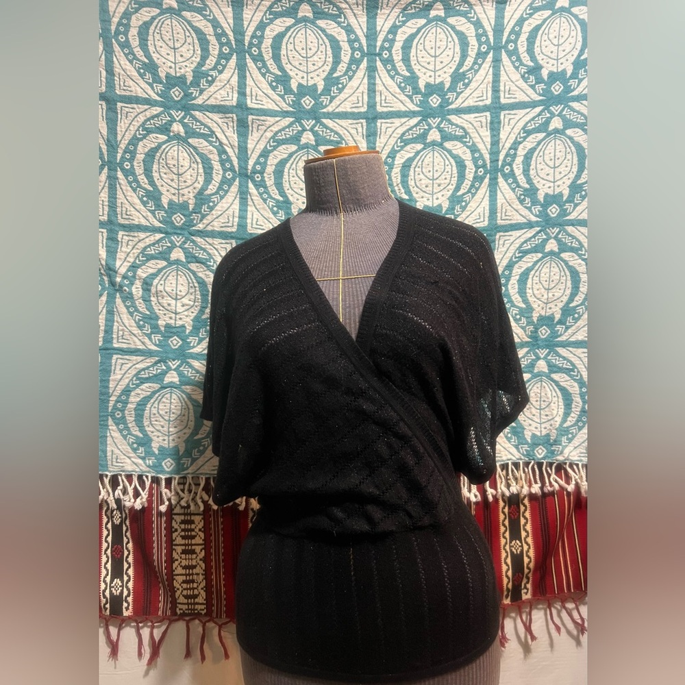 Small black sweater with tapered waist